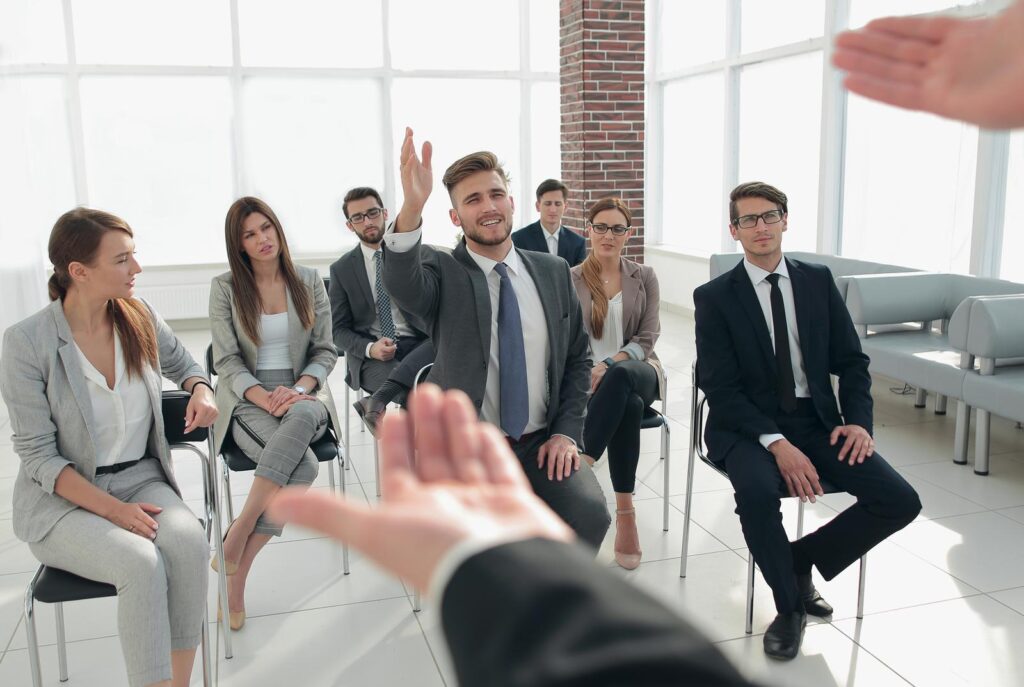 listener asks a question to the coach at the business seminar.business and education